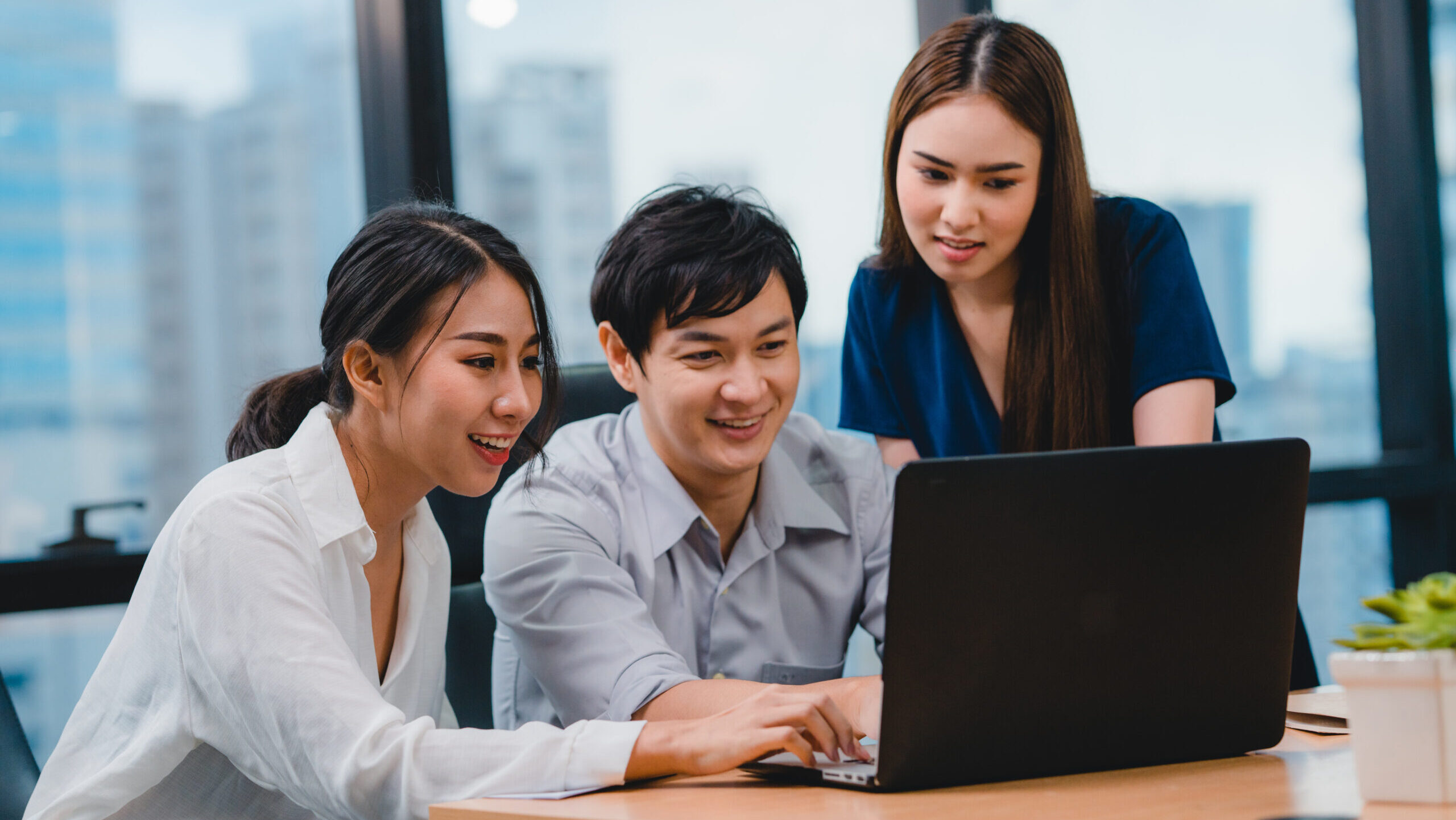 Collaborative process of multicultural businesspeople using laptop presentation and communication meeting brainstorming ideas about project colleagues working plan success strategy in modern office.